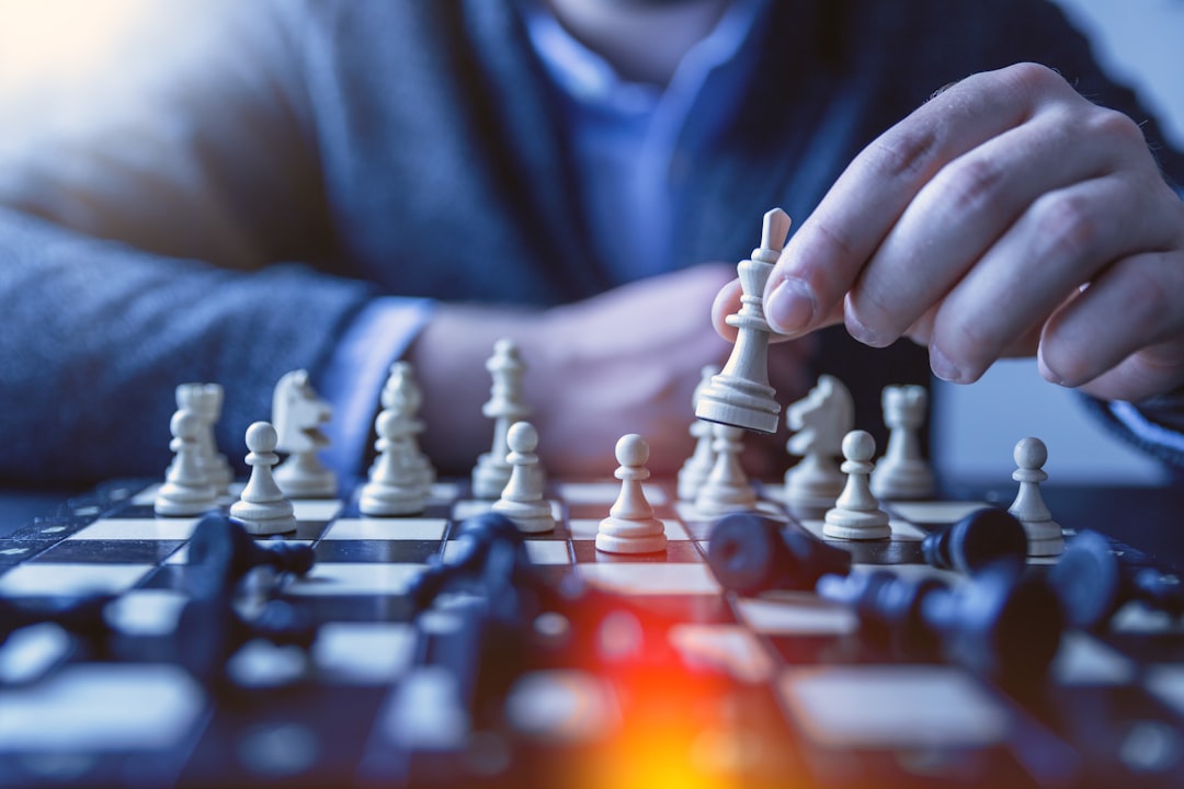 depth-of-field-photography-of-man-playing-chess-fzoitus1diq